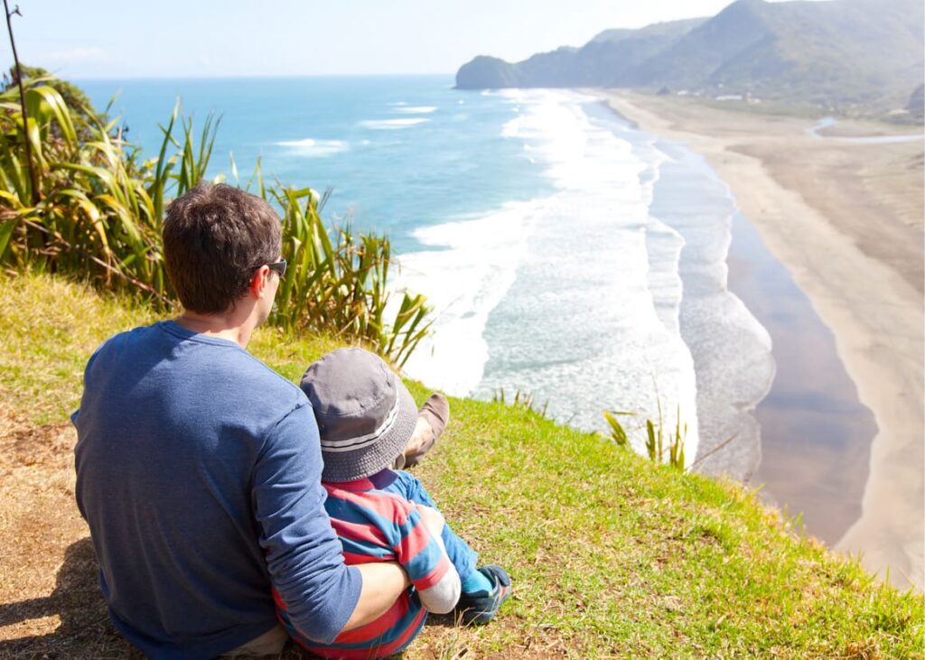 A young family looking at the beach in New Zealand. Making a new life in new Zealand 