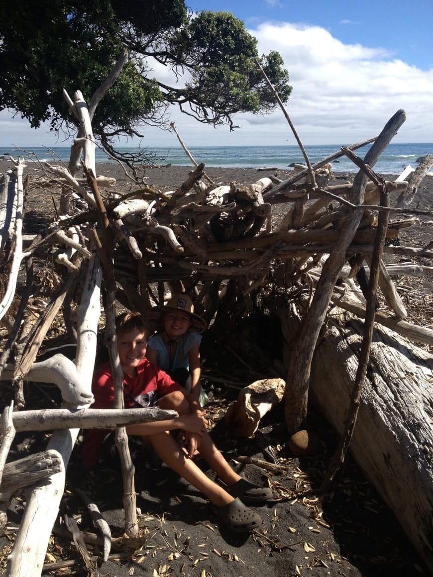 Homeschooling in a driftwood hut made on the beach