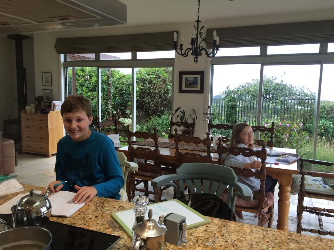 Two children doing their work while homeschooling