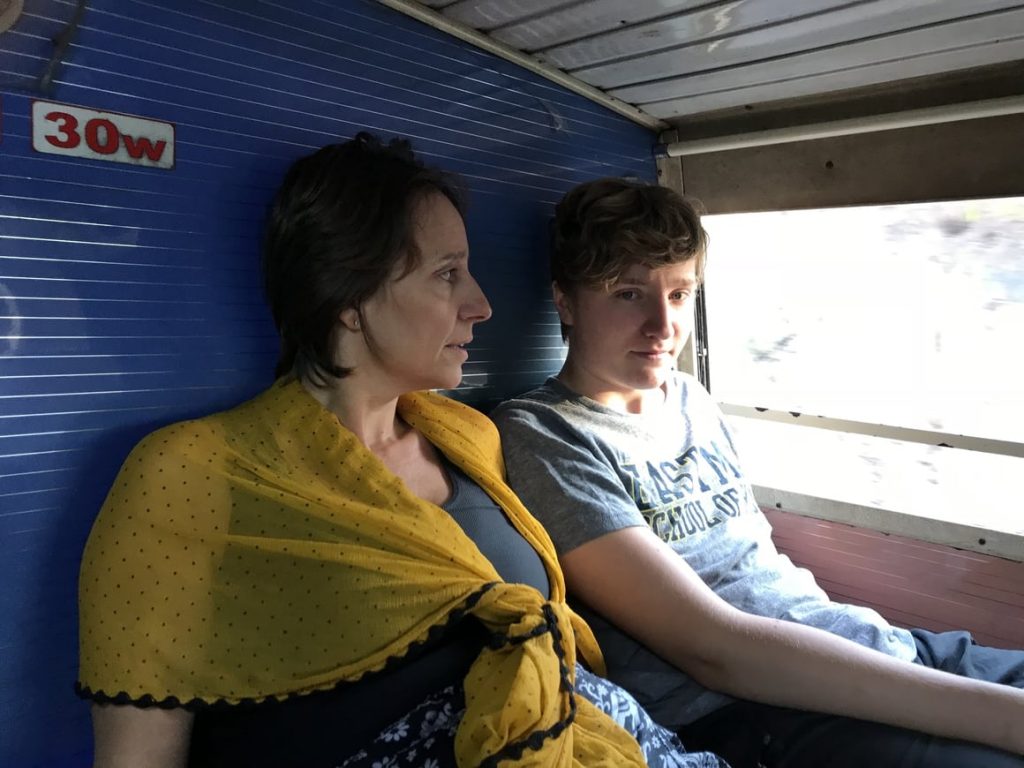 A family travelling in India on a sleeper bus