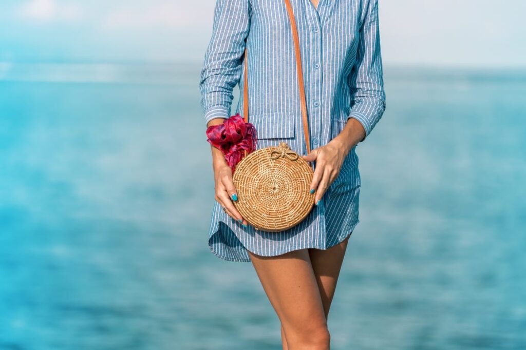 woman with travel purse on the beach