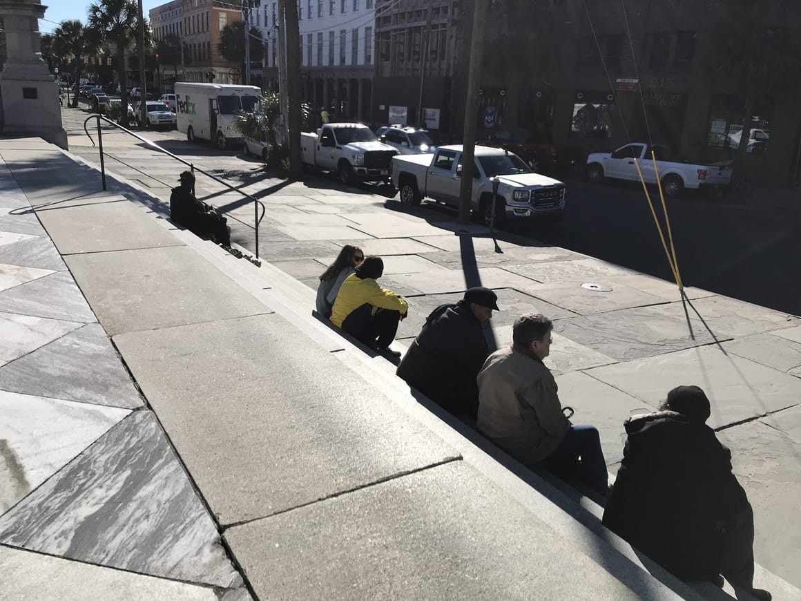 people watching on steps in Charleston SC