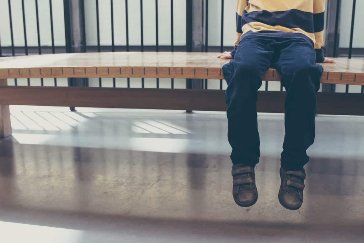 Child sitting on a bench in a museum