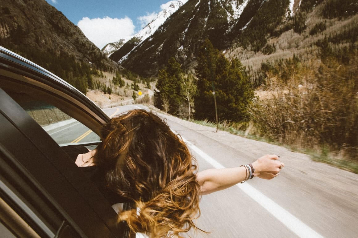 Woman in a car taking a road trip