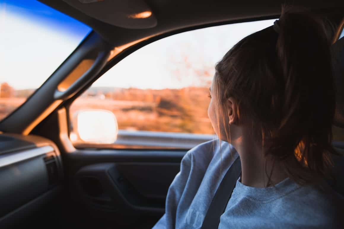 Woman in a car taking a road trip