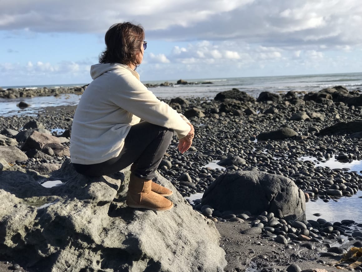 Woman sitting looking out to see thinking about how to be a successful homeschooling schedule