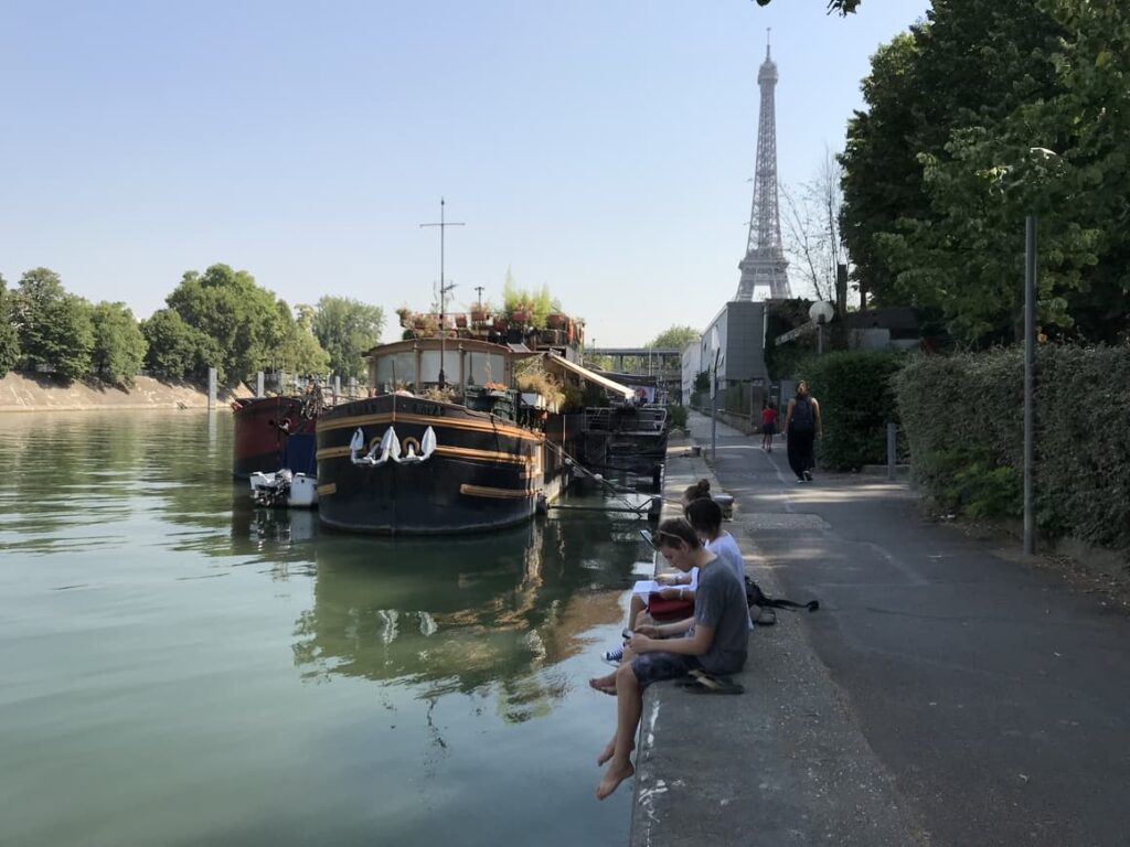 Family sitting by the river seine in Paris. One of the most beautiful places in the world