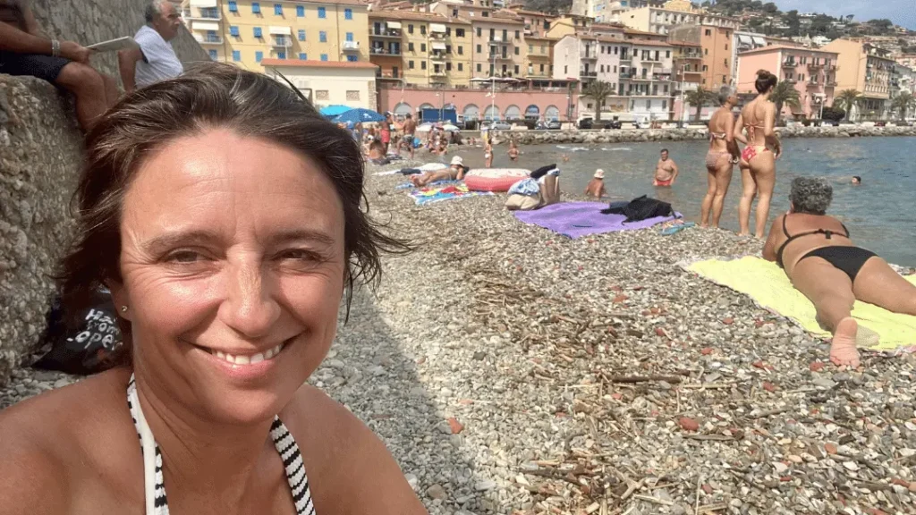 Woman at beach in Italy. best Travel Podcast