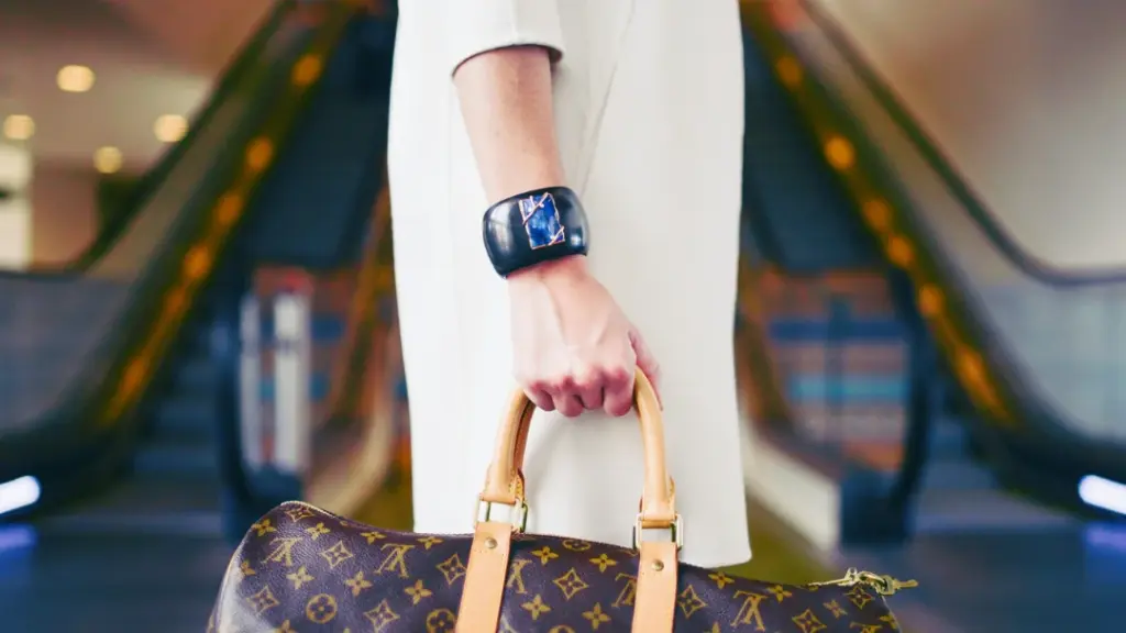 Woman holding a carry on bag filled with essentials for the flight