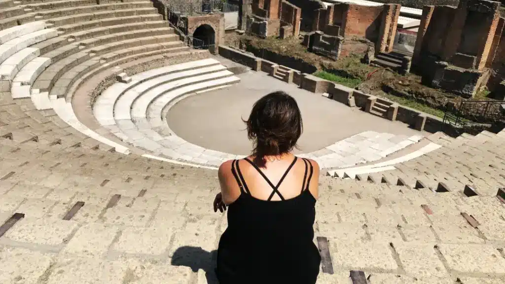 A woman in Italy in summer with her back to the camera