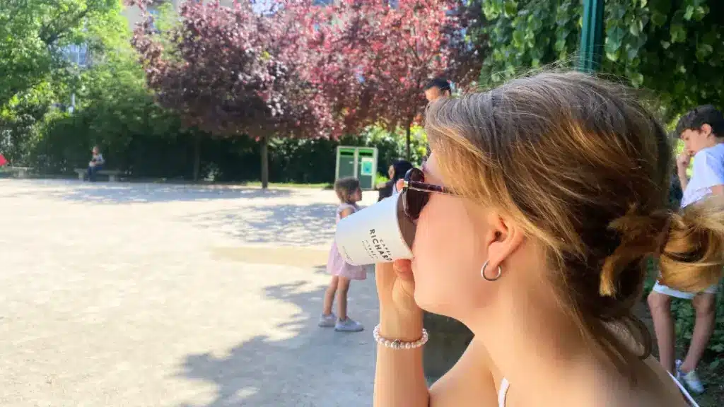 A girl in Paris drinking coffee