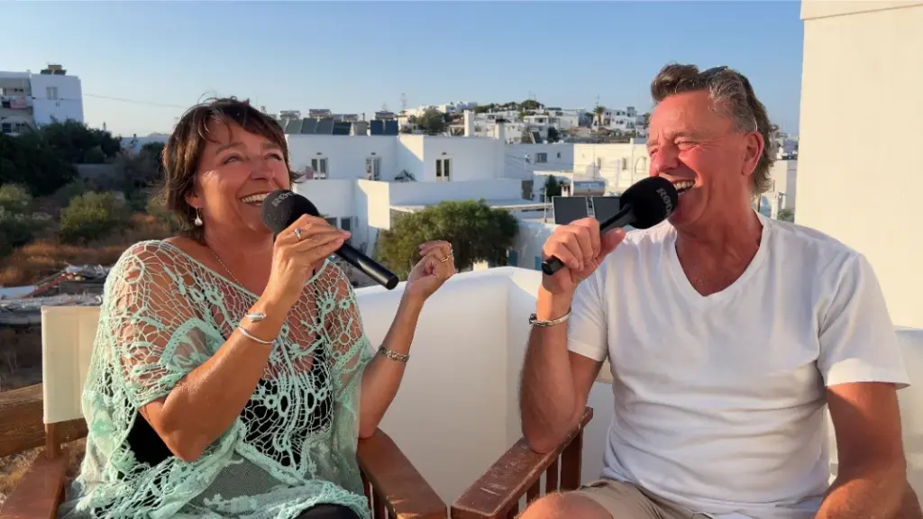 A husband and wife recording a podcast from Naousa, on the Greek island of Paros about travel in Greece.