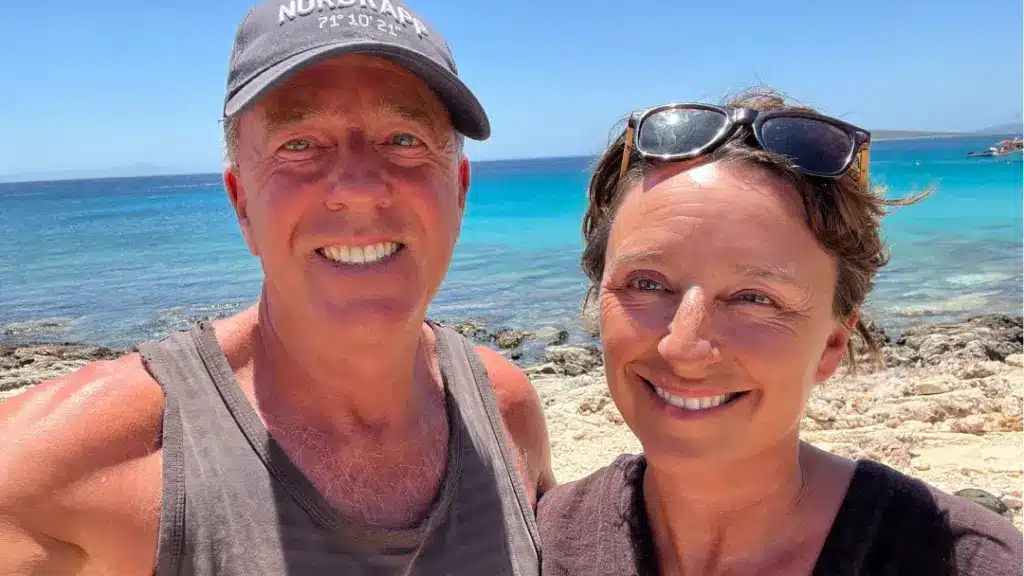 A husband and wife recording a podcast from Naousa, on the Greek island of Paros about travel in Greece. It's a Marriage