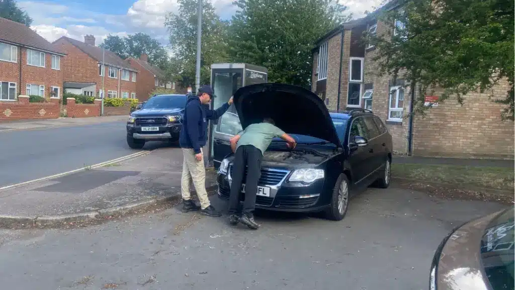 Husband looking at a car in England. The It's a drama marriage podcast. 