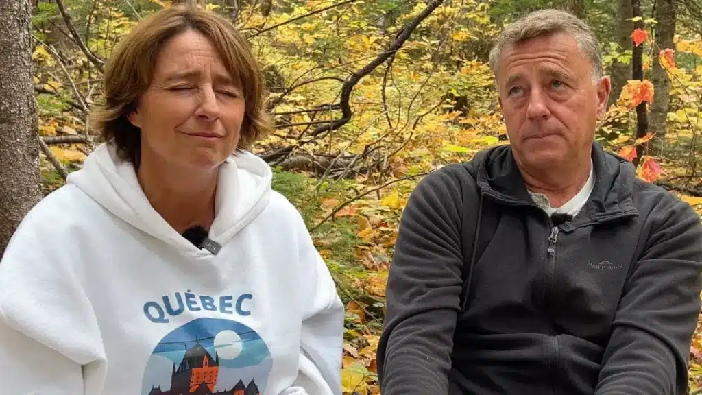 Married couple Liz and Brain talking in the Canadian forest on their podcast "It's a Drama" about feeling scared to do what makes Liz happy while on a two year sabbatical with her family in Canada