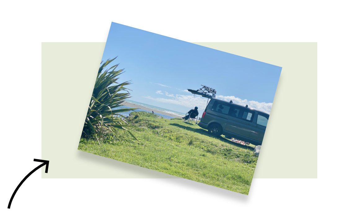 A woman sitting outside her motorhome in New Zealand