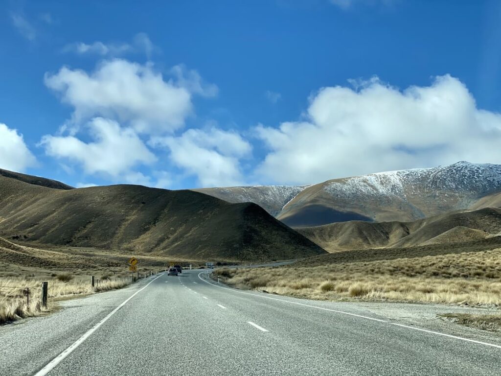 A road with mountains in the background in New Zealand