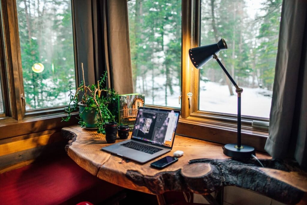 Computer on a desk with a lamp shining . Working from home tips