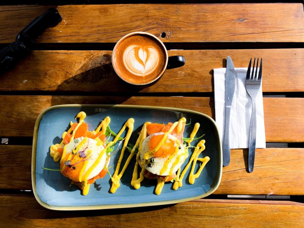 Plate of delicious looking food in nEw Zealand with a cup of coffee