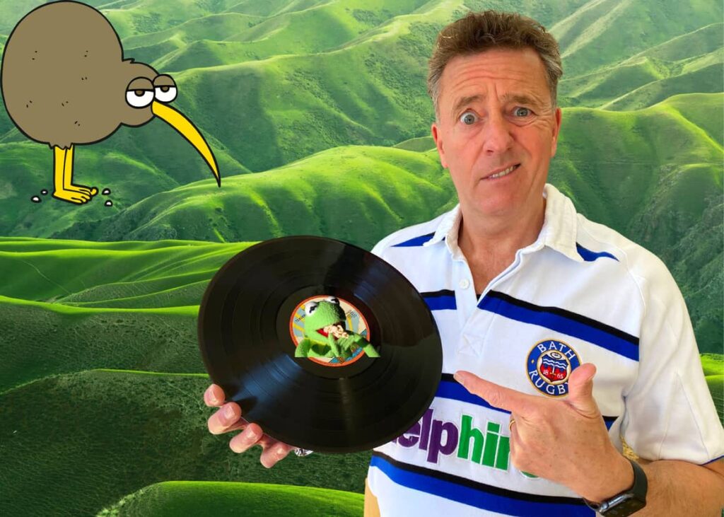 Man holding a record with a New Zealand kiwi bird looking at him. Weird New Zealand Facts!