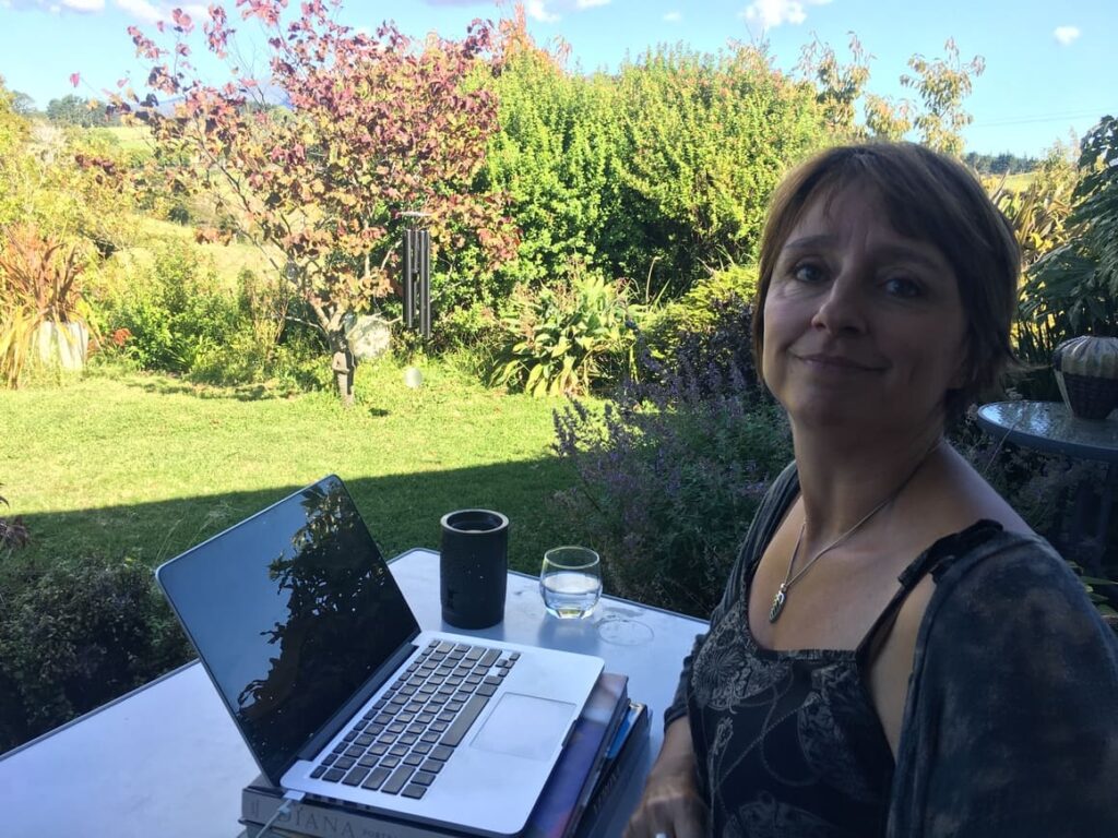 Woman working from home on her computer out side in the garden