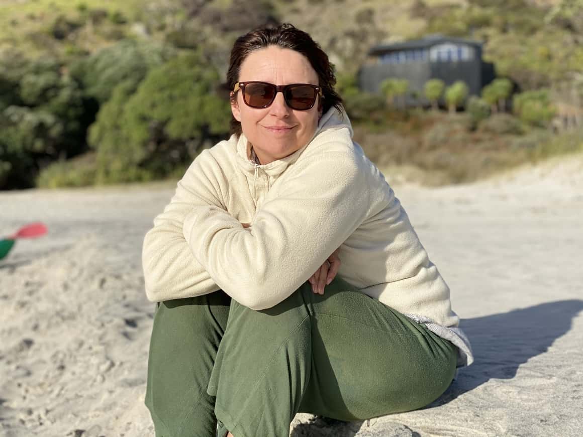 Liz on beach in New Zealand