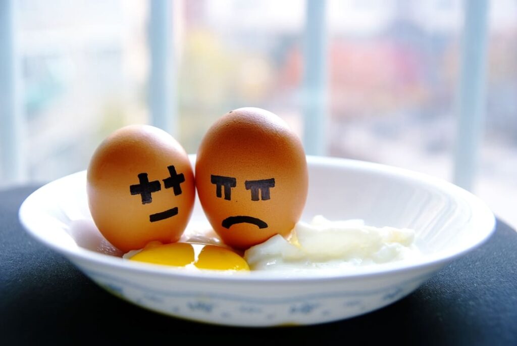 Two eggs with angry faces drawn onto them