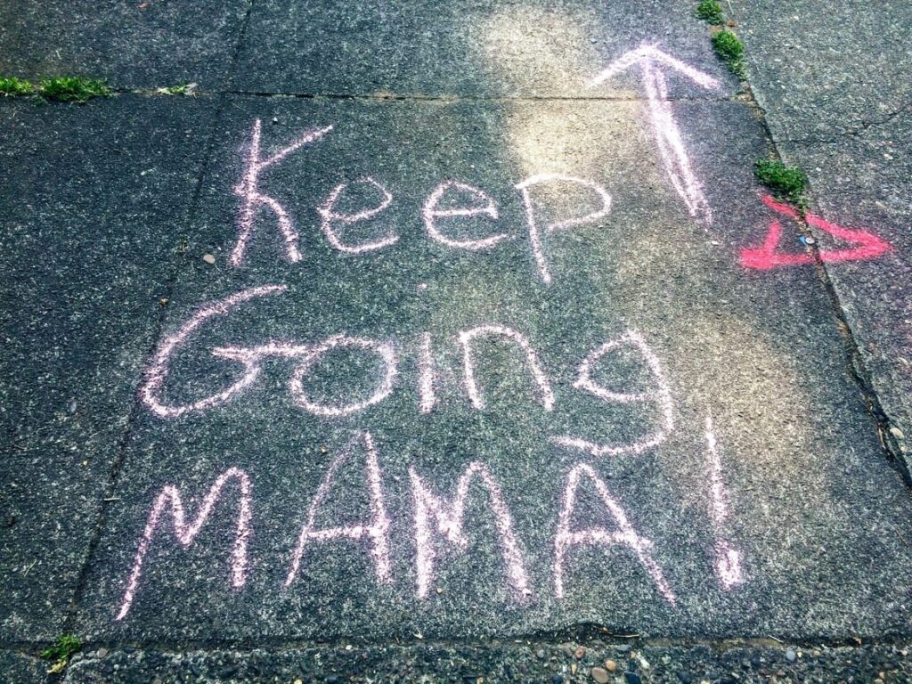 A sign in the road that encourages mothers to keep going to be a successful homeschooling parent!