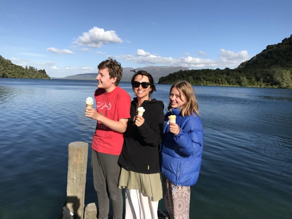 mother and two children standing in front of a lake in New Zealand