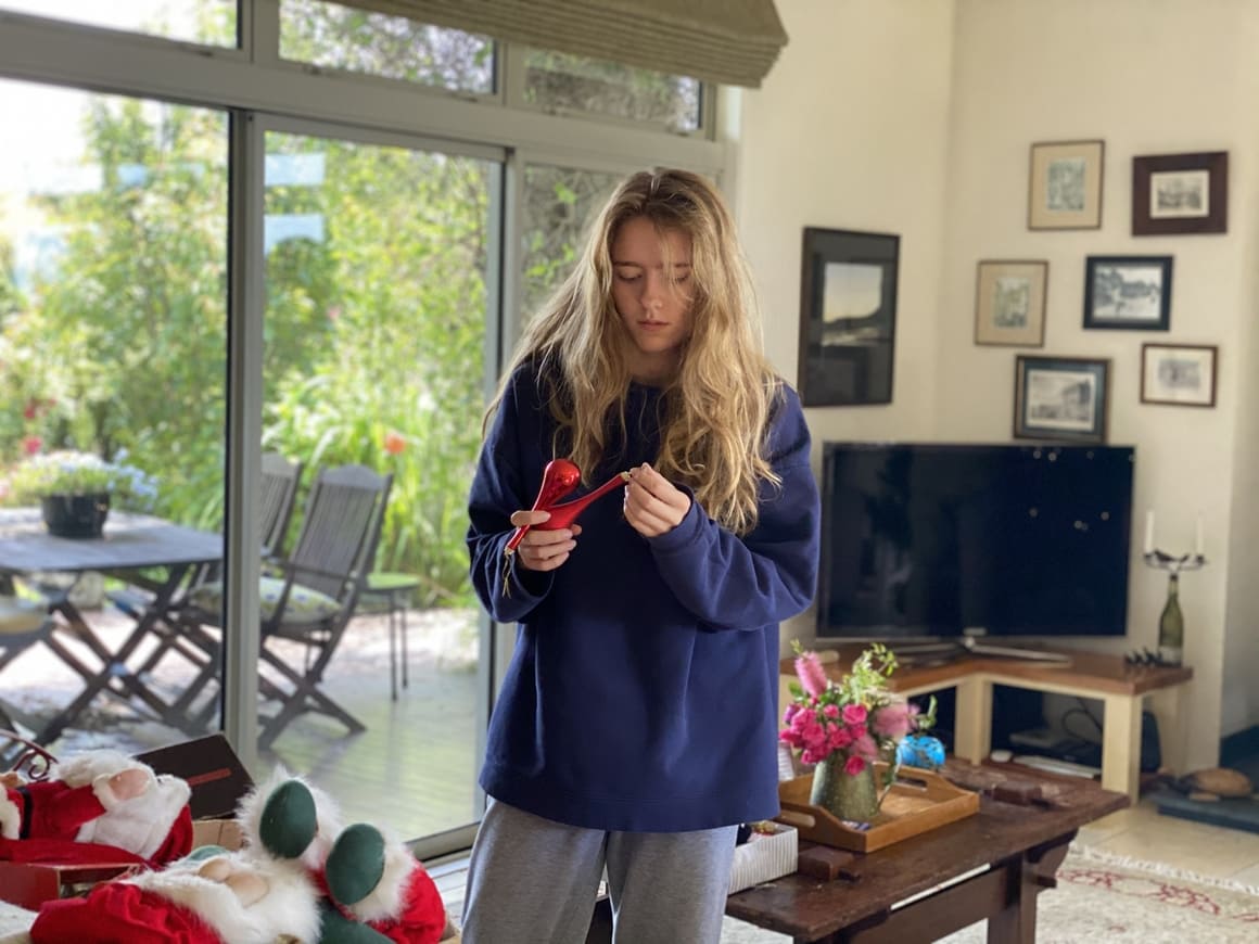 Girl decorating a tree in New Zealand