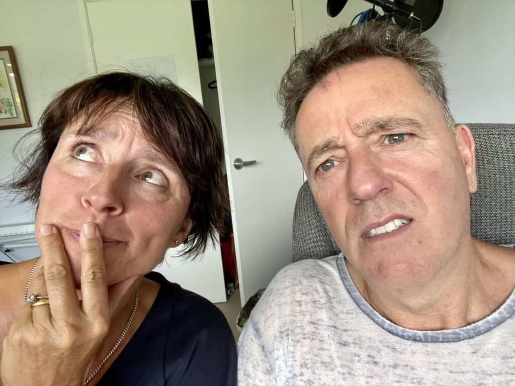 Man and woman looking confused as they don;t know whether to continue with their New Zealand podcast